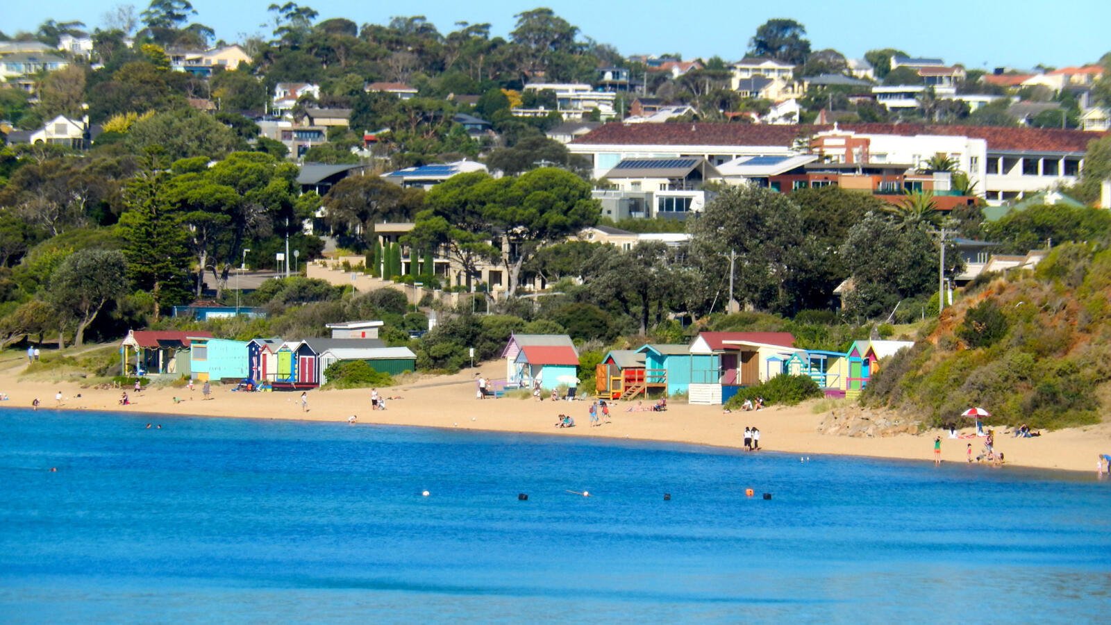 Colorful beach bathing boxes along the shore in Mornington Peninsula near a trusted flooring store in Mornington.