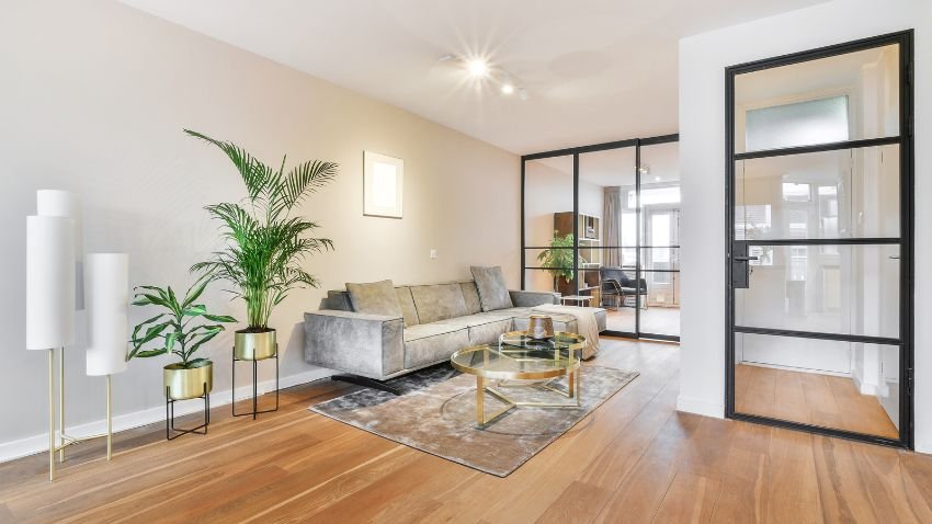 Modern open-plan living space featuring warm neutral flooring trends for 2026