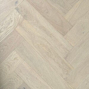 Shell Herringbone hybrid flooring in a light beach-inspired pattern.